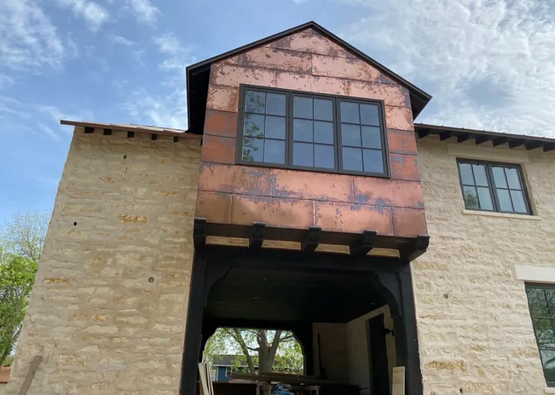 Copper metal panel facade on a stone building for Skylight Installation in Loyalsock